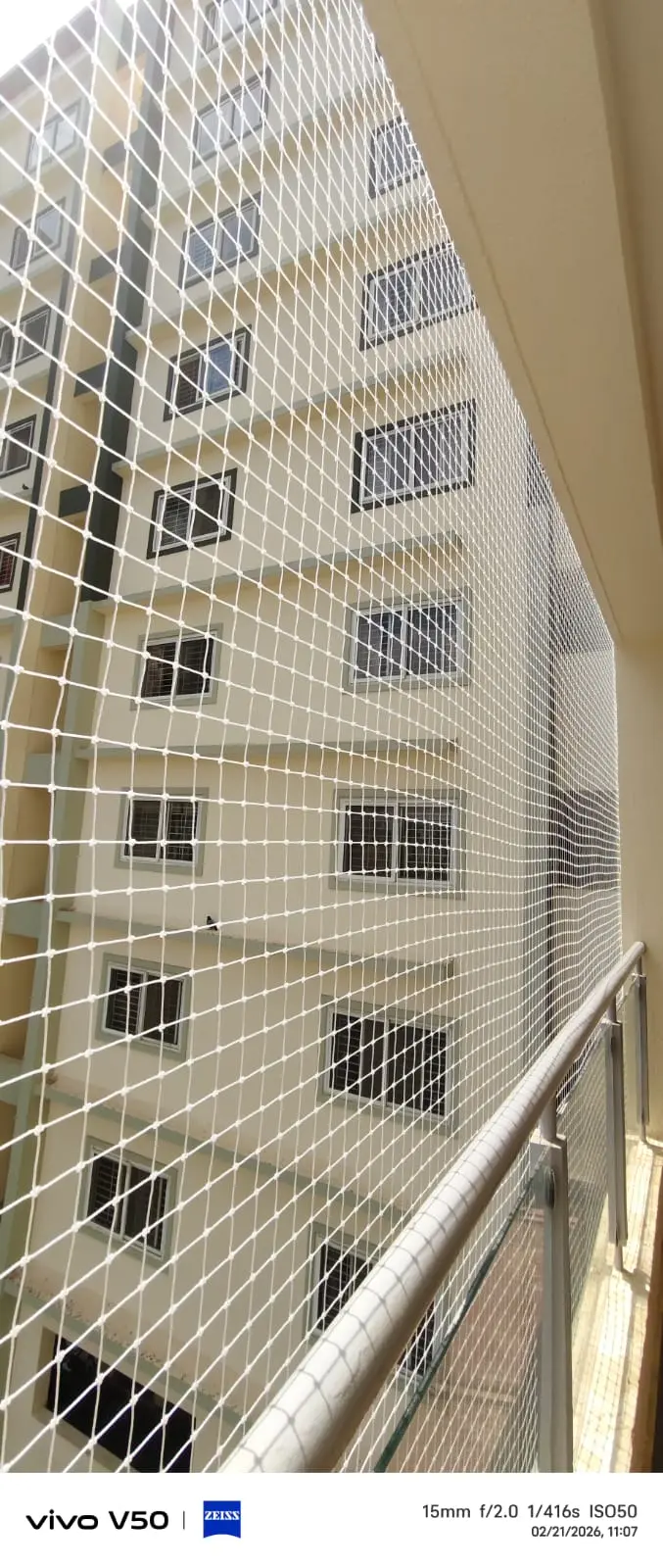 Anti-bird mesh installation preventing bird intrusion on balcony